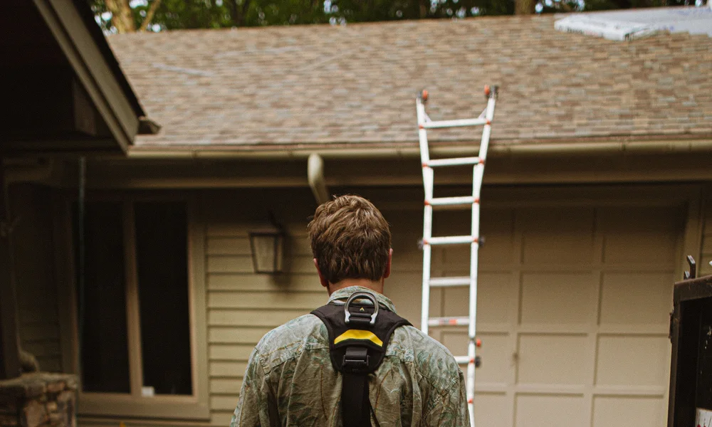 Roofing professional at work on a residential roof