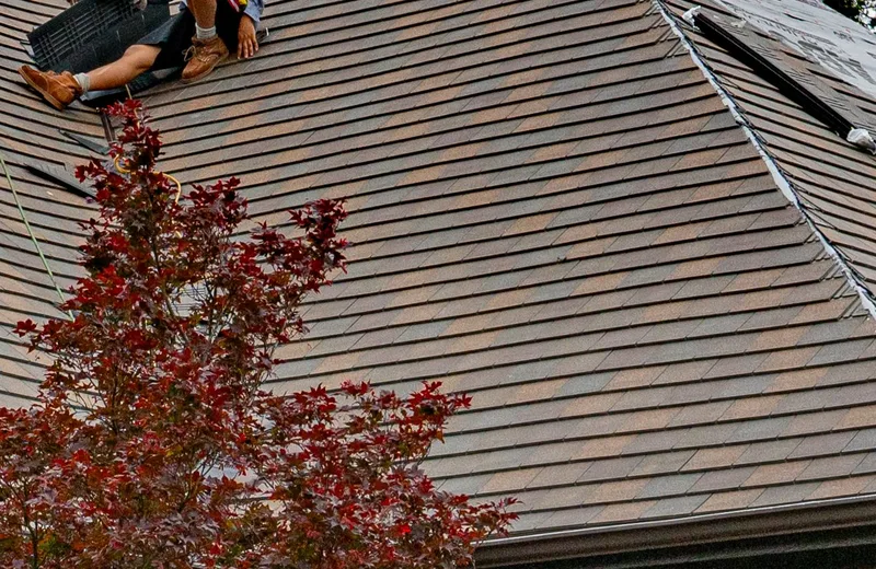 Roof valleys and shingles around a chimney on a residential roof